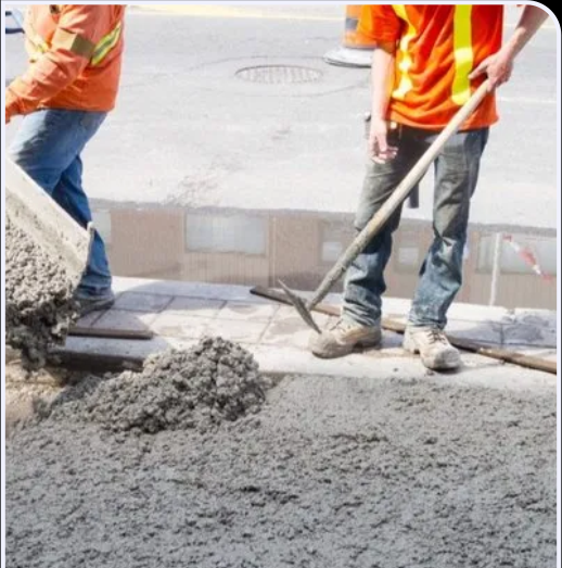 Concrete being placed and levelled on site